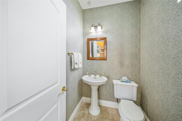 bathroom featuring toilet and tile patterned floors