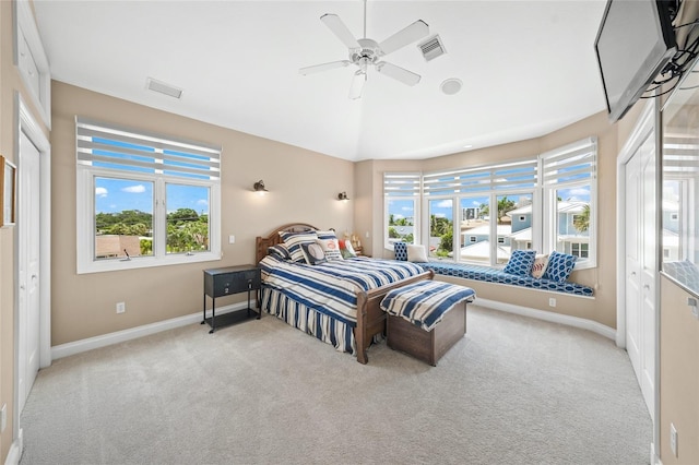 carpeted bedroom featuring a closet, ceiling fan, and lofted ceiling