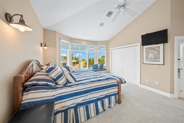 carpeted bedroom with ceiling fan, a closet, and lofted ceiling