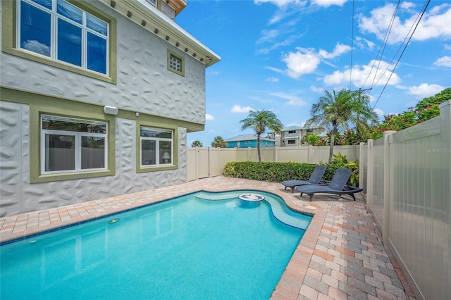 view of swimming pool featuring a patio area