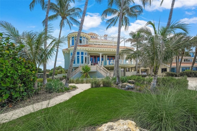 exterior space with covered porch and a yard