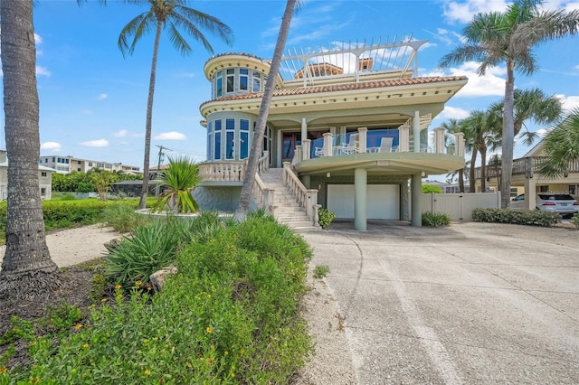 mediterranean / spanish-style home featuring a porch and a garage