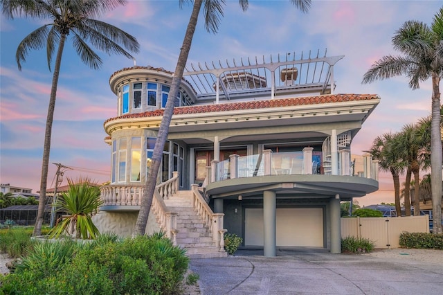 view of front of house with a garage and a balcony