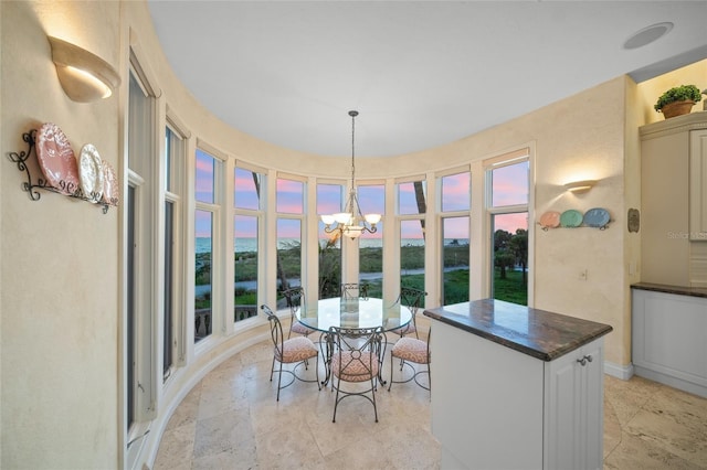 sunroom / solarium featuring a chandelier and a wealth of natural light