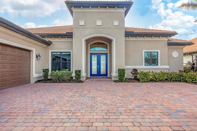 view of exterior entry featuring a garage