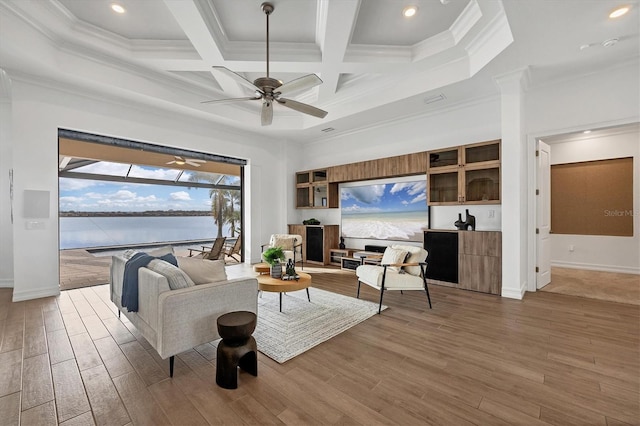 living room with light wood-style flooring, a high ceiling, ornamental molding, and coffered ceiling