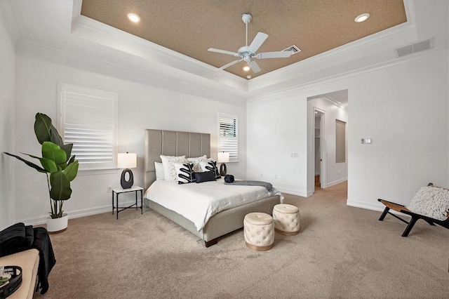 bedroom with ceiling fan, crown molding, light colored carpet, and a raised ceiling