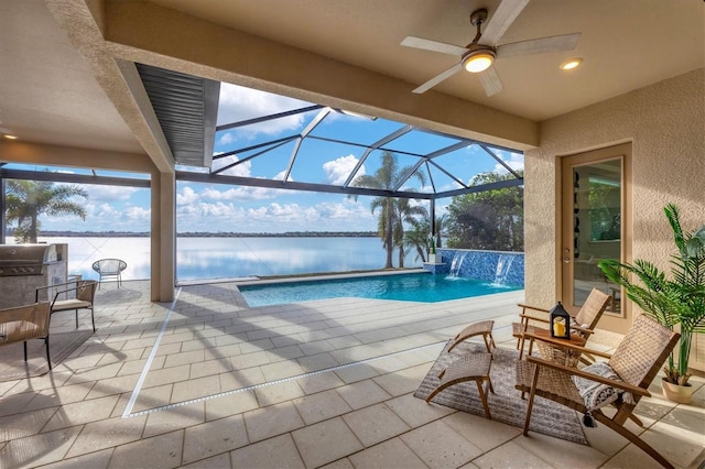 pool featuring a patio area, glass enclosure, a water view, and a ceiling fan