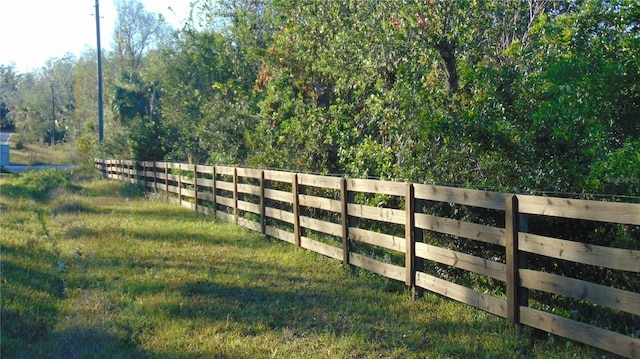 view of gate featuring a lawn