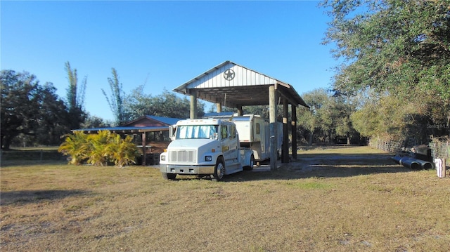 exterior space featuring a yard and a carport