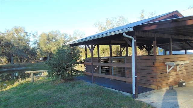 view of stable with a water view