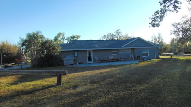 ranch-style home with a patio area and a front lawn