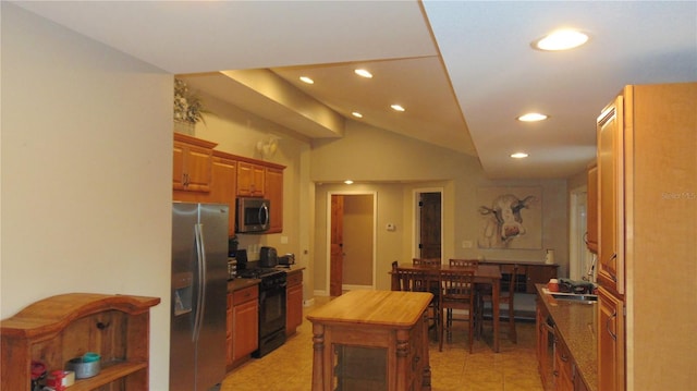 kitchen featuring light tile patterned floors, appliances with stainless steel finishes, and lofted ceiling