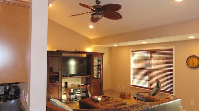 living room featuring ceiling fan and lofted ceiling