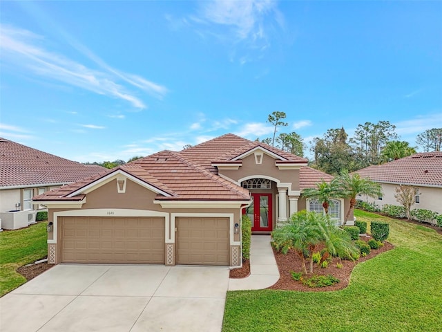 mediterranean / spanish-style house with a garage and a front lawn