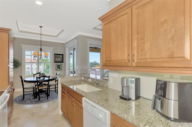 kitchen with a raised ceiling, sink, white dishwasher, light stone countertops, and a chandelier