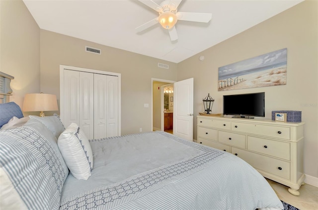 tiled bedroom with ceiling fan and a closet