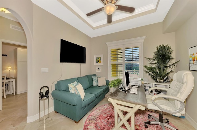 office area featuring ceiling fan, a tray ceiling, and ornamental molding