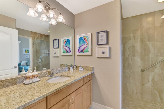 bathroom featuring vanity, a shower with door, and a chandelier