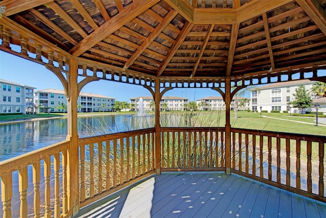 wooden deck featuring a gazebo and a water view