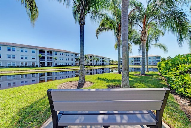 view of community featuring a water view and a lawn