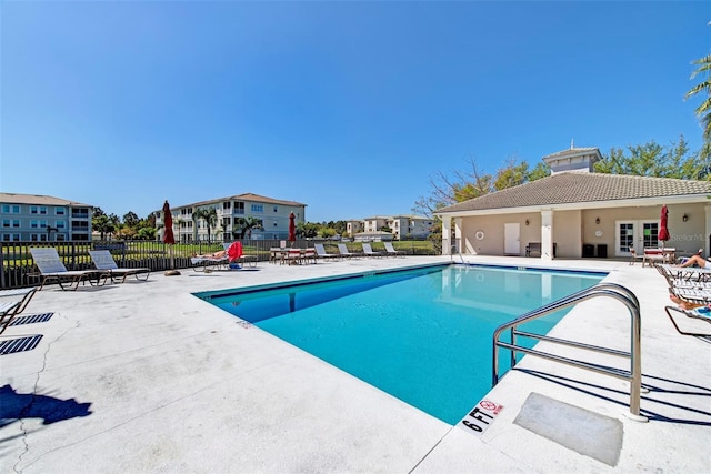 view of pool featuring french doors and a patio