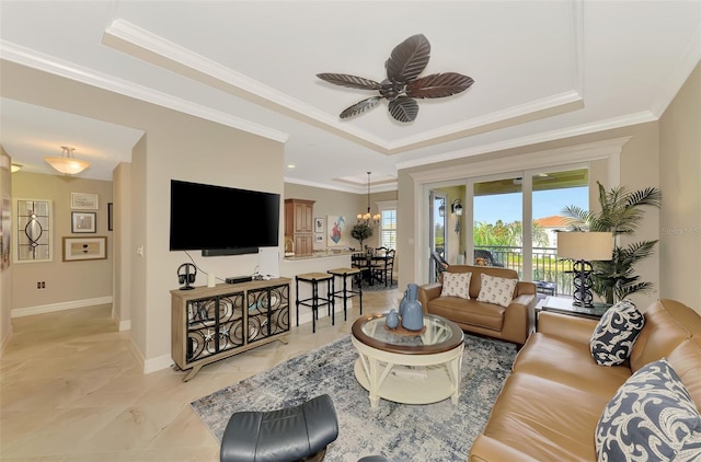 living room with crown molding, ceiling fan, and a tray ceiling