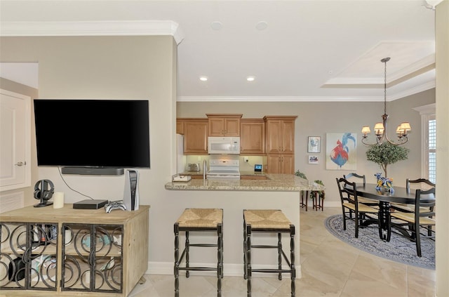 kitchen with light stone counters, electric range oven, kitchen peninsula, and a chandelier