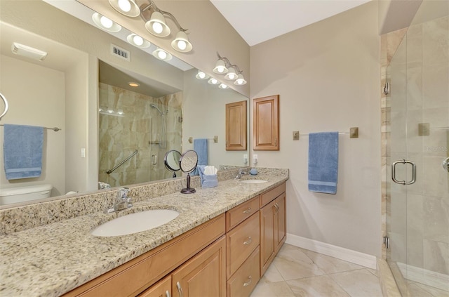 bathroom featuring an enclosed shower, vanity, and toilet