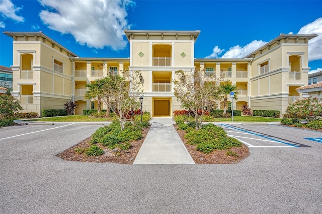 view of building exterior featuring uncovered parking