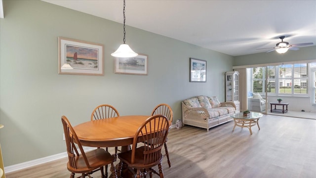 dining room with ceiling fan and light wood-type flooring