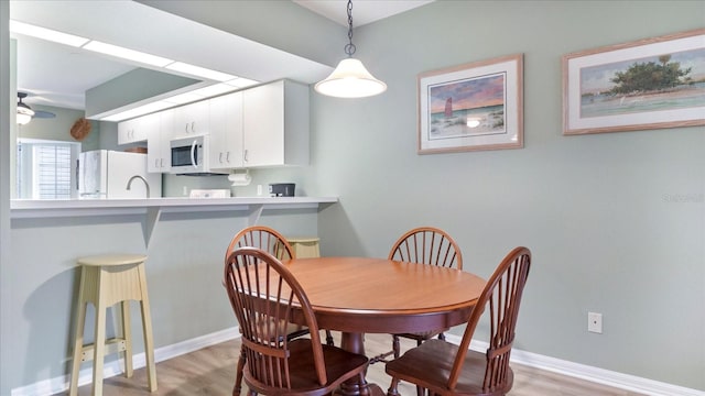 dining space with light wood-type flooring