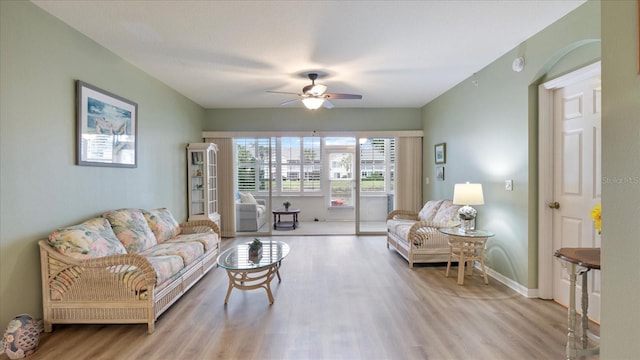 living room featuring ceiling fan and light hardwood / wood-style floors