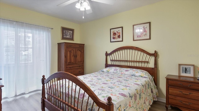 bedroom with ceiling fan and light hardwood / wood-style floors