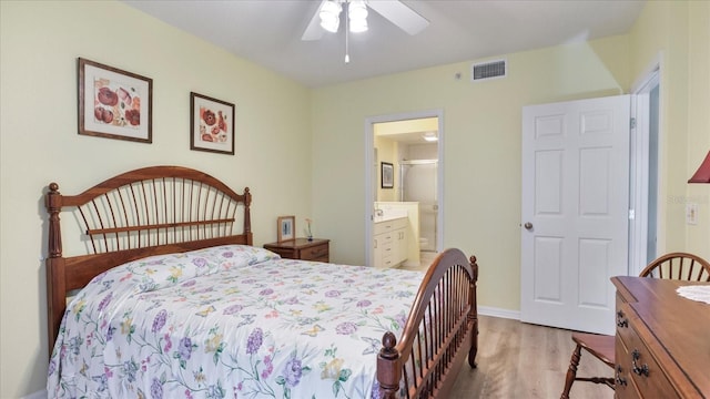 bedroom featuring ceiling fan, ensuite bath, and light hardwood / wood-style flooring