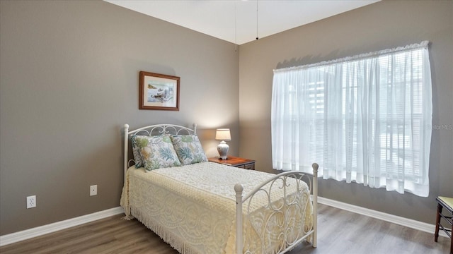 bedroom with hardwood / wood-style floors