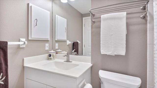 bathroom with toilet and vanity