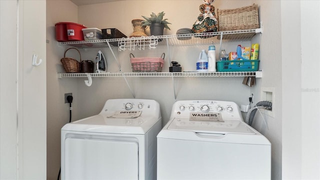 clothes washing area featuring separate washer and dryer