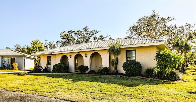 mediterranean / spanish house with a front yard