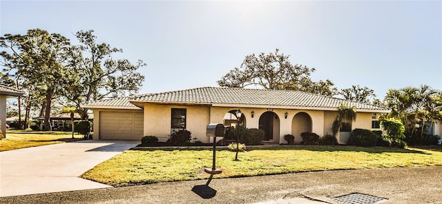 mediterranean / spanish-style home with a garage and a front yard