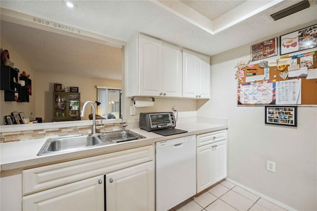 kitchen featuring a textured ceiling, dishwasher, white cabinetry, sink, and light tile patterned floors