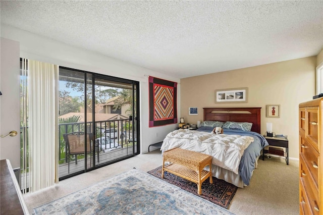 bedroom featuring a textured ceiling, light colored carpet, and access to exterior