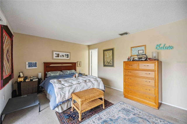 bedroom with carpet and a textured ceiling