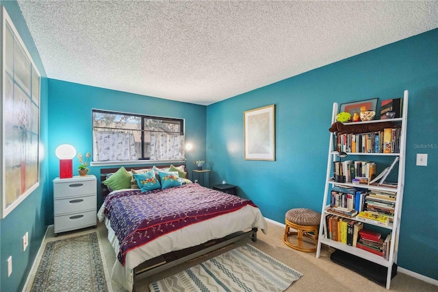 bedroom featuring a textured ceiling and carpet flooring