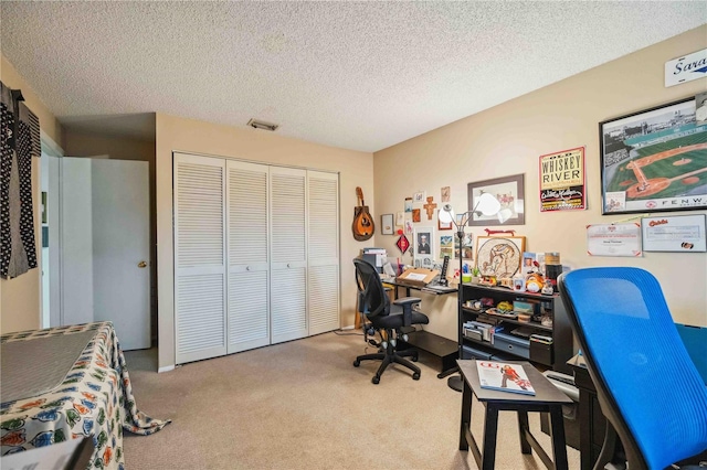 carpeted home office with a textured ceiling