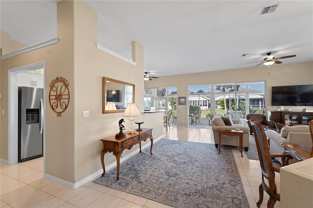 tiled living room with ceiling fan