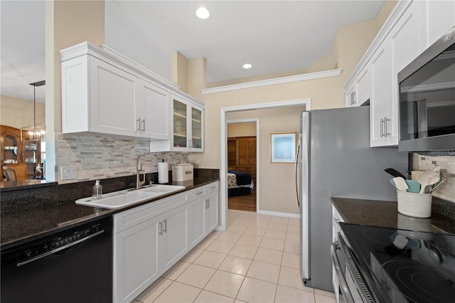 kitchen with sink, white cabinets, stainless steel appliances, and tasteful backsplash