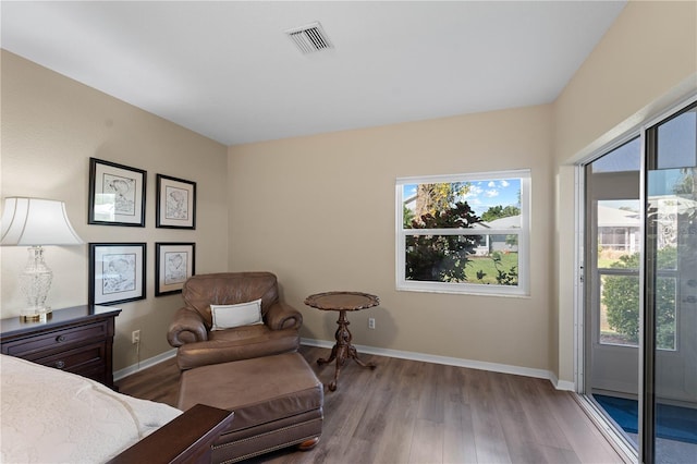 bedroom featuring light hardwood / wood-style floors, access to exterior, and multiple windows