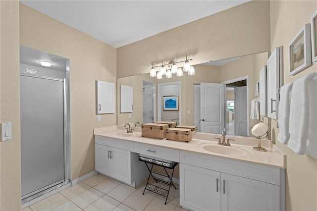 bathroom with a shower with shower door, tile patterned floors, and vanity