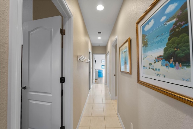 corridor featuring light tile patterned floors